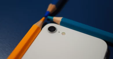 smartfon iPhone SE i kredki na blacie